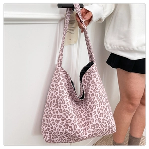 Detail of leopard print suede tote bag with black lining and wide shoulder strap