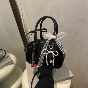 Chic black matte bowling bag with lace bows, cherry pendant, and pearl heart chain strap