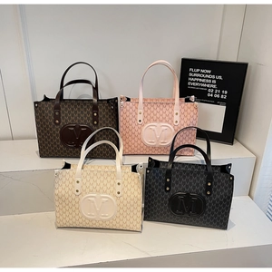 Classic M-pattern tote bags in brown, pink, white, and black colors displayed on steps