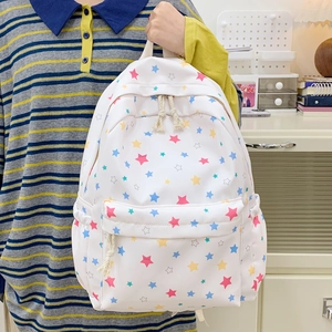White Japanese style student backpack with colorful star patterns and woven rope zippers