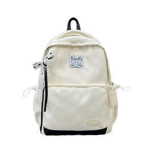 Cream canvas backpack with angel wing patch and decorative ribbon for students