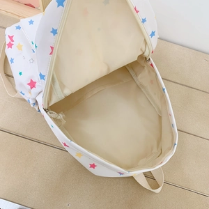 Japanese style white canvas backpack with colorful star patterns and wide zipper opening