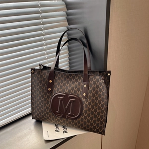 Brown leather tote bag with M-letter monogram print and spacious shoulder straps