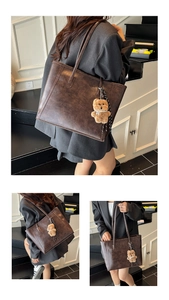 Close-up of vintage brown tote bag with textured faux leather and bear charm detail