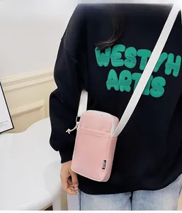 Pink striped nylon crossbody phone bag with adjustable strap and sport tag detail
