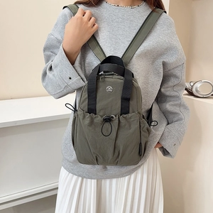 Olive green mini nylon backpack with drawstring pocket and metallic logo for women