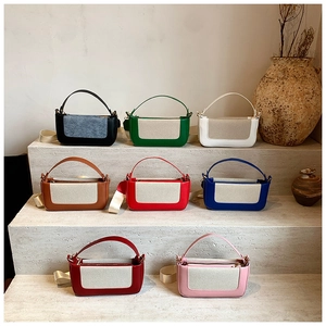 Multiple stylish contrast patchwork handbags in eight colors displayed on stone steps