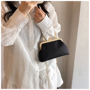 Vintage black jacquard kiss-lock bag with gold chain strap shown in a mirror selfie