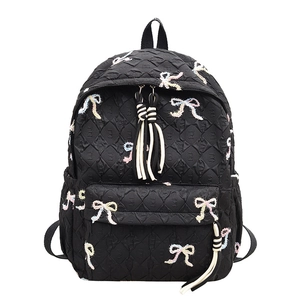 Black quilted backpack with colorful bows and striped tassel for students and travel