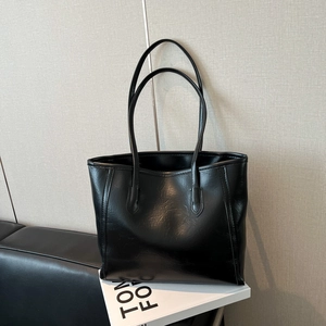 Classic black tote bag in glossy faux leather for women's daily commute fashion