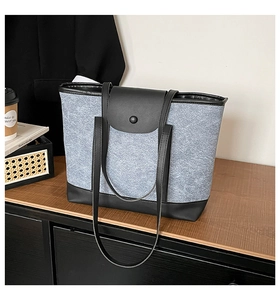 Gros plan d'un sac cabas bicolore sur un bureau avec café et livres au bureau