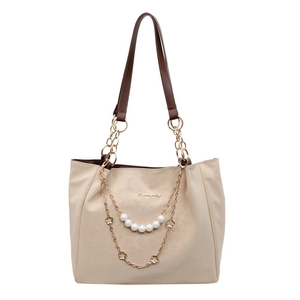 Beige tote bag with pearl chain and gold floral charms for casual office wear