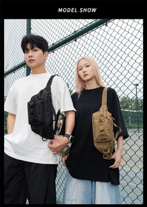 Dual models wearing black and khaki tactical sling bags in an outdoor sports setting