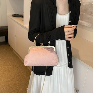 Elegant pink jacquard silk handbag with golden frame clasp and delicate metal chain strap