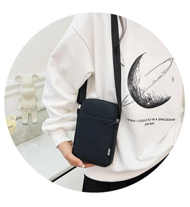Detail view of the black nylon cell phone bag featuring a white SPORT logo patch