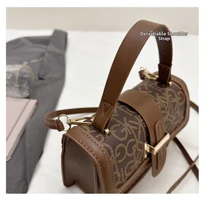 Detail of the vintage monogram pattern handbag with gold-tone metal hardware and strap