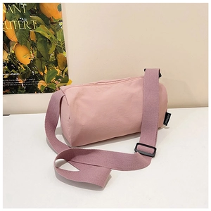 Detail of pink nylon barrel bag with woven strap and Lanweier brand label