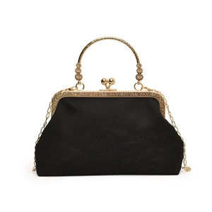 Elegant black landscape jacquard shell bag with gold clasp and floral handle detail
