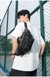 Close-up of camouflage tactical crossbody bag with MOLLE webbing for outdoor sports gear