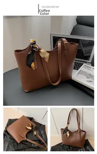Detail of coffee brown PU leather tote bag handle featuring a floral silk scarf accent