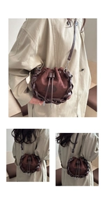 Detail of dark brown suede bucket bag with braided leather trim and drawstring closure