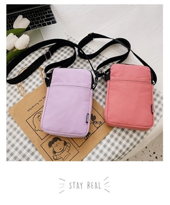Detailed view of purple nylon and pink corduroy mini crossbody phone bags with sport tags