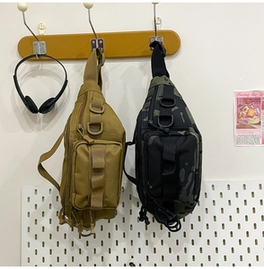 Detail view of khaki and black camo tactical chest bags with functional MOLLE webbing and D-rings