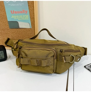 Detail view of khaki tactical waist bag with MOLLE webbing and durable zipper pockets