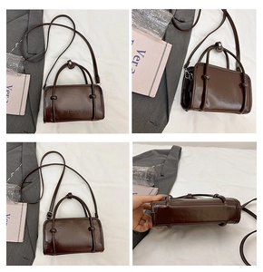 Detail view of smooth brown leather tote bag with FASHION logo and detachable strap