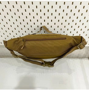 Detailed view of tactical waist bag in coyote brown with durable nylon and adjustable buckle