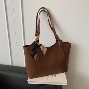 Brown vintage faux leather tote bag with elegant printed silk scarf and adjustable strap