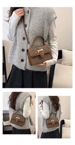 Detailed view of vintage brown crossbody bag with letter print and golden buckle