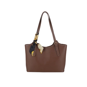 Brown tote bag with white stitching, decorative silk scarf and adjustable shoulder straps