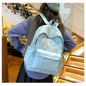 Macro detail of large capacity blue backpack with star and moon print for students