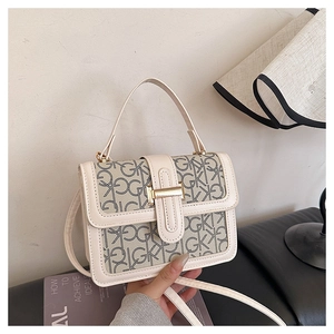 Detail of vintage beige crossbody bag featuring dark brown GK monogram and gold buckle clasp