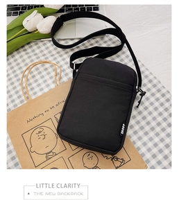 Detail of black nylon crossbody phone bag with SPORT label and adjustable strap