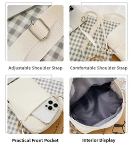 Detail view of adjustable wide strap and internal storage of the white nylon phone bag