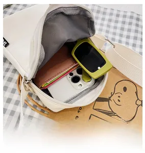 Top view of the white nylon crossbody bag interior showing spacious storage for phone and wallet