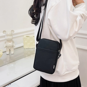 Minimalist black nylon crossbody bag for women with adjustable strap and sport label