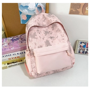 Detail view of pink school backpack with moon star prints and multi-pocket design