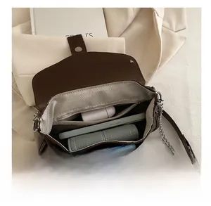 Detail showing spacious interior of dark brown punk style shoulder bag with metal chain