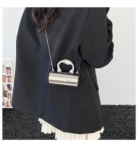 Silver metallic cylindrical crossbody bag with high-gloss mirror finish and chain strap