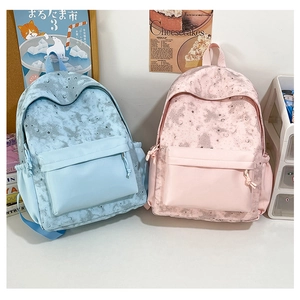 Detail of star and moon print backpacks in light blue and pink for students
