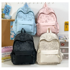 Detail view of stylish backpacks with star and moon prints in four soft colors