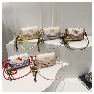 Detail view of five checkered plaid crossbody bags with cute bear charms in soft colors