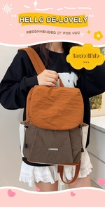 Close-up of color-block travel backpack in orange and brown with white side pockets