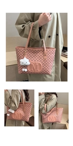 Pink tote bag detail with letter print pattern and fluffy cloud charm accessory