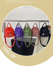 Detailed view of mini nylon crossbody bags in red, purple, green, pink, and black
