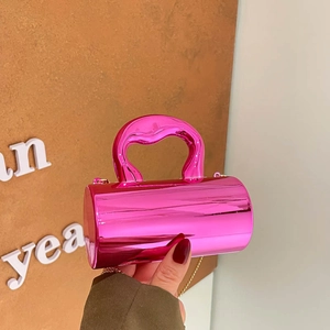 Glossy neon pink cylindrical crossbody bag with gold chain strap and top handle