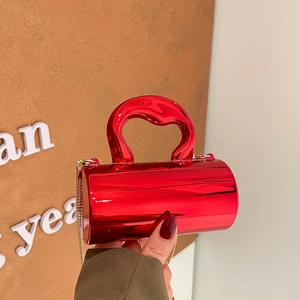 Modern cylinder metallic red handbag with streamlined top handle and gold chain strap
